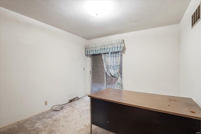 unfurnished office featuring visible vents and light colored carpet