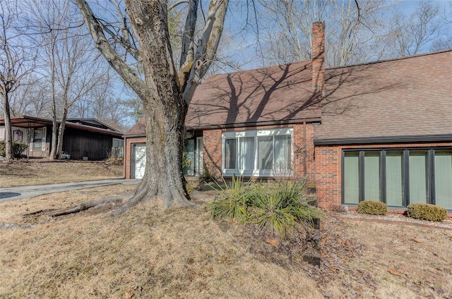 view of side of home with a yard and a garage