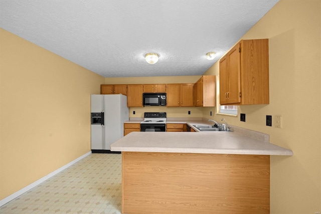 kitchen featuring white appliances, kitchen peninsula, sink, and a textured ceiling