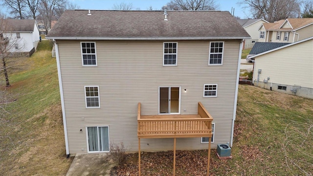 rear view of property with a balcony, a lawn, and central air condition unit