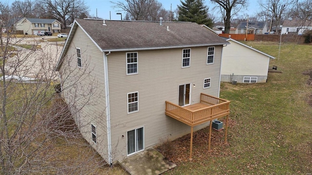 back of property featuring a wooden deck, central AC, and a lawn