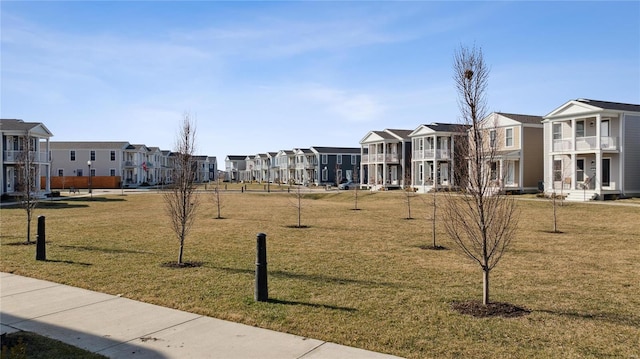 view of community featuring a yard and a residential view