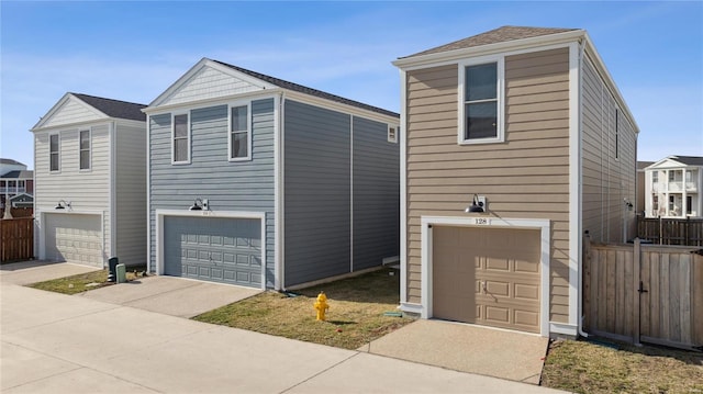 view of front of house with a garage and fence