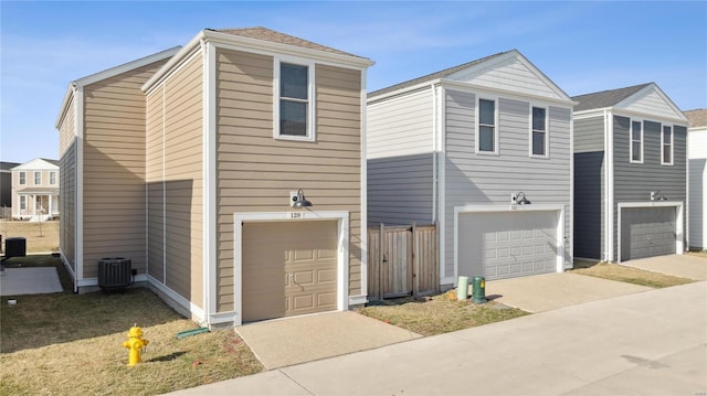 view of front of house with central AC and an attached garage