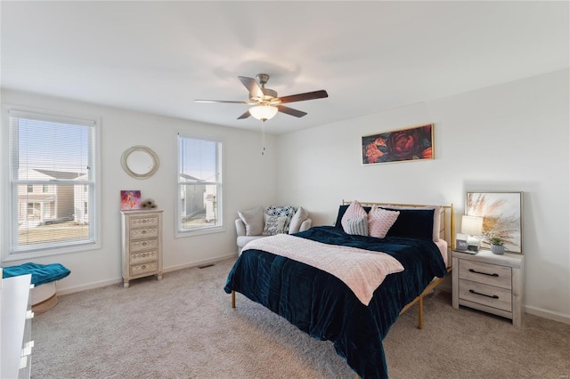 carpeted bedroom with ceiling fan, visible vents, and baseboards