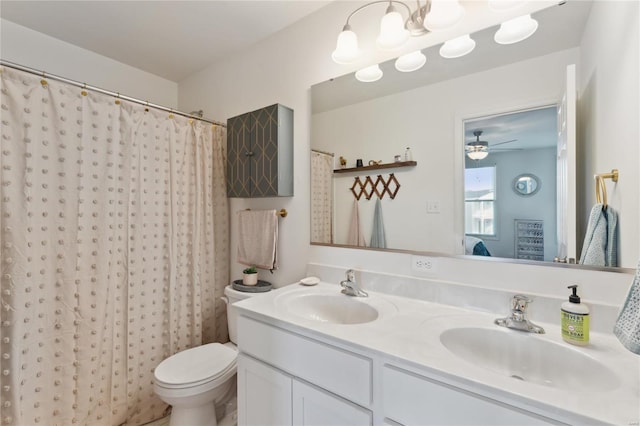 bathroom with toilet, double vanity, and a sink