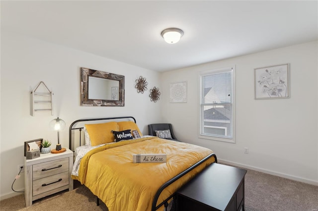 carpeted bedroom featuring baseboards