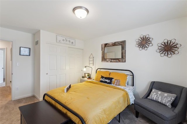 carpeted bedroom with a closet, visible vents, and baseboards