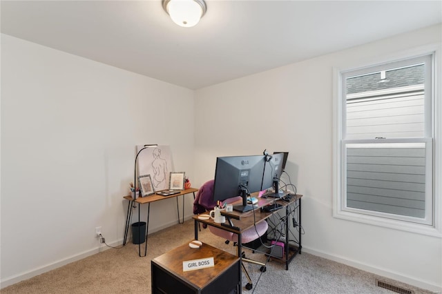 office area with light carpet, visible vents, and baseboards