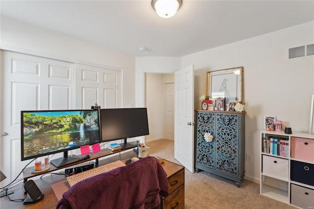 office space with light carpet, visible vents, and baseboards