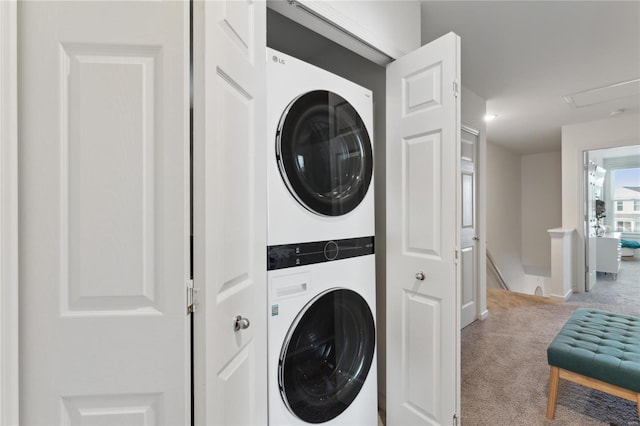 laundry room with stacked washer / drying machine, laundry area, and carpet flooring