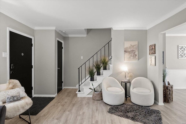 living area featuring ornamental molding and light hardwood / wood-style floors