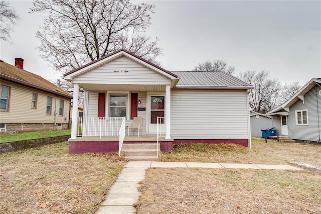 bungalow-style house featuring a porch and a front yard