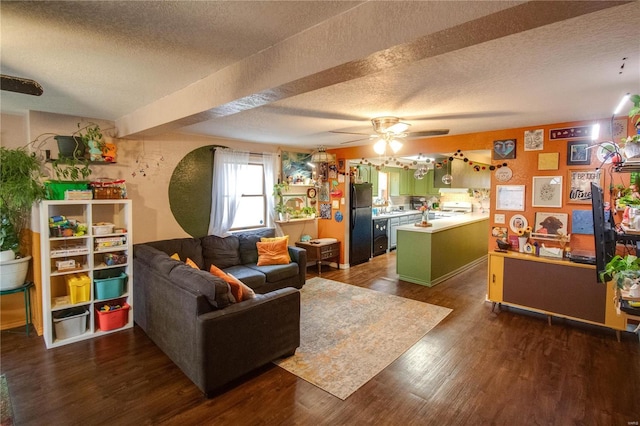 living room featuring dark wood-type flooring, ceiling fan, and a textured ceiling