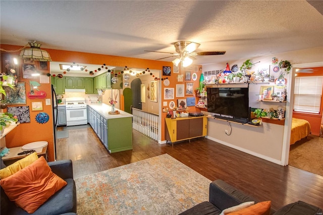 kitchen featuring green cabinetry, a textured ceiling, white electric stove, dark hardwood / wood-style flooring, and ceiling fan