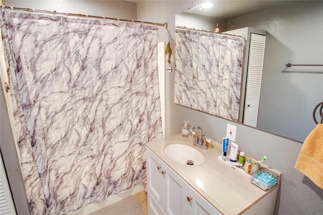 bathroom with vanity and a shower with shower curtain