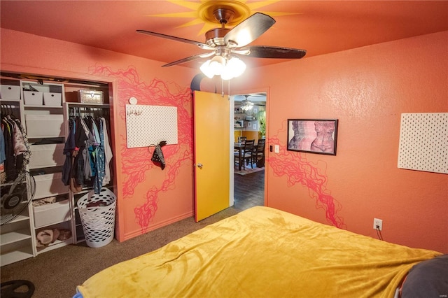 bedroom featuring ceiling fan, dark carpet, and a closet