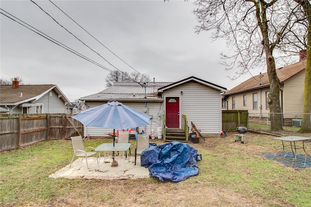 rear view of house with a yard and a patio