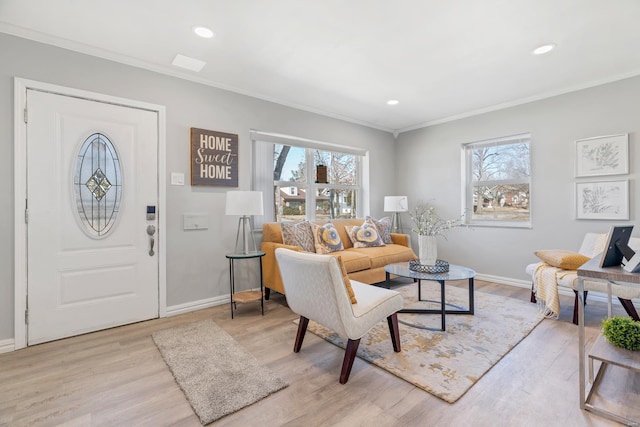 interior space featuring ornamental molding, light wood finished floors, baseboards, and a healthy amount of sunlight