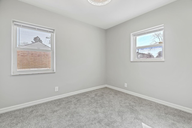 carpeted empty room with baseboards