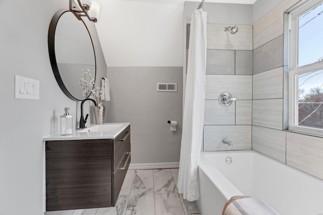 full bath featuring marble finish floor, a wealth of natural light, visible vents, and baseboards