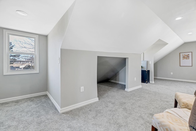 additional living space with recessed lighting, carpet flooring, vaulted ceiling, and baseboards