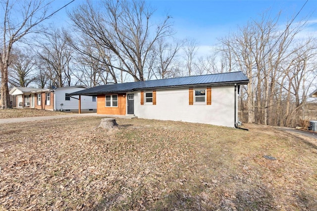 single story home with a front yard and central air condition unit