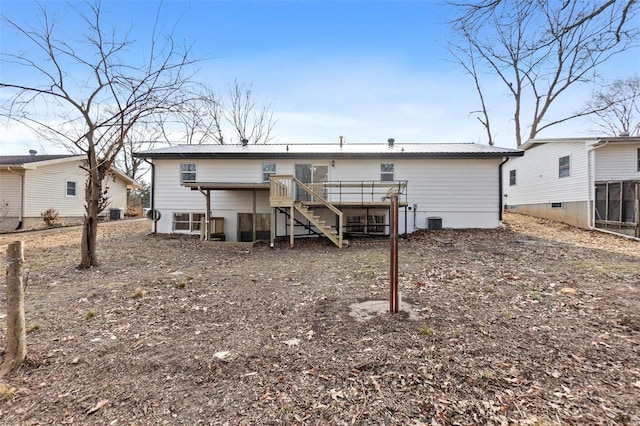 back of house with central AC and a deck