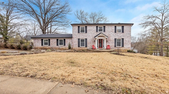 colonial home with a front yard