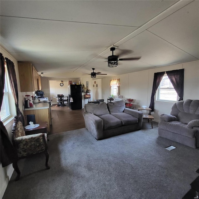 living room featuring vaulted ceiling and ceiling fan