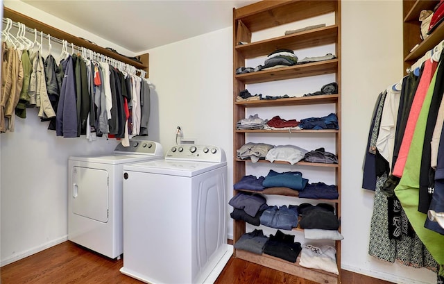 clothes washing area featuring dark hardwood / wood-style floors and washing machine and clothes dryer