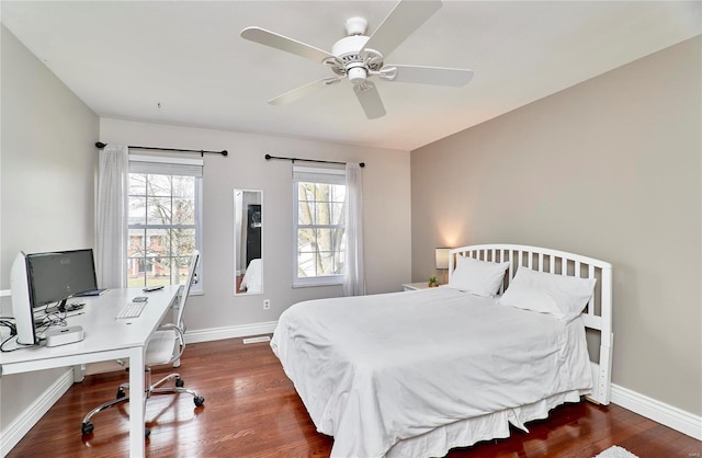 bedroom with ceiling fan and dark hardwood / wood-style flooring