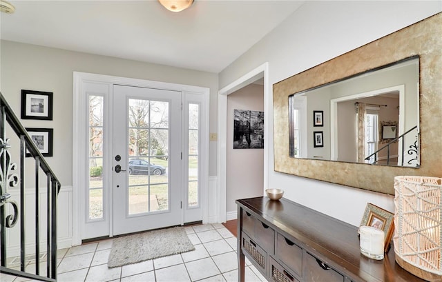 foyer entrance with light tile patterned flooring