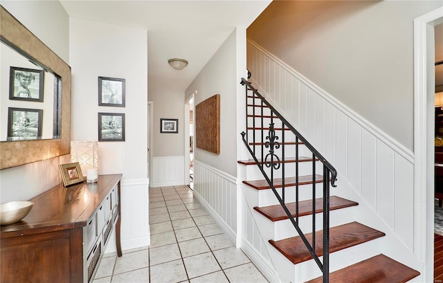 stairway featuring tile patterned flooring