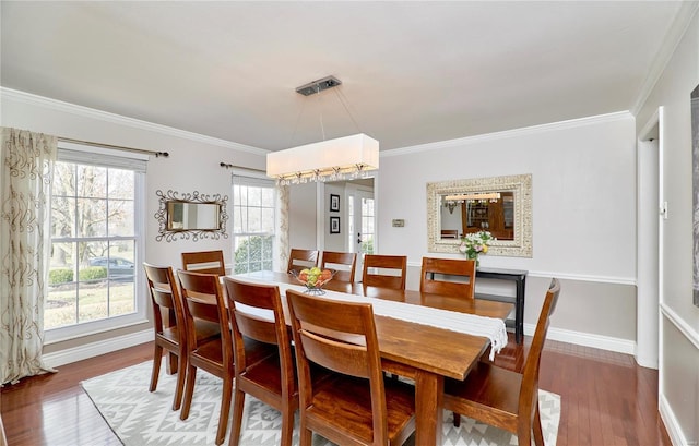 dining area with hardwood / wood-style flooring and ornamental molding