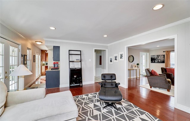 living room with dark wood-type flooring and crown molding