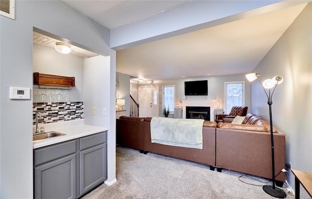 living room featuring indoor wet bar and light carpet