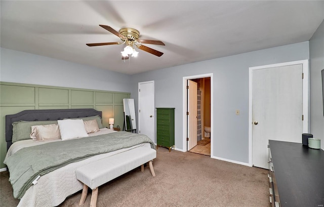 bedroom featuring carpet, ceiling fan, and ensuite bath