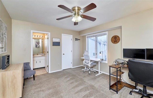 carpeted home office with sink and ceiling fan