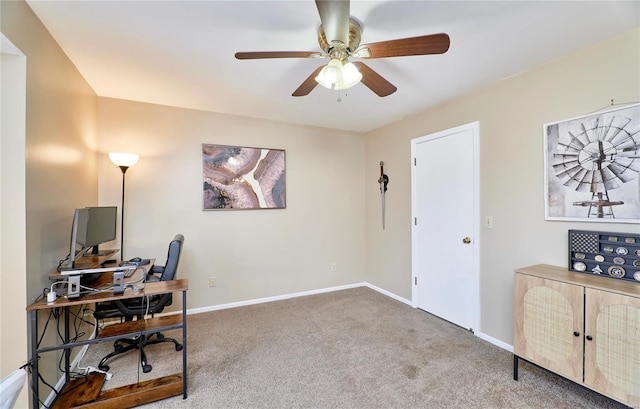 carpeted home office featuring ceiling fan