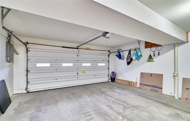 garage with a garage door opener and electric panel