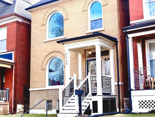 view of exterior entry featuring brick siding