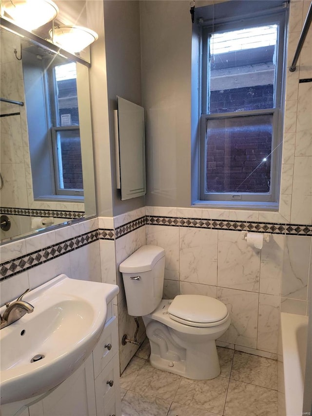 bathroom with a bath, marble finish floor, vanity, and toilet