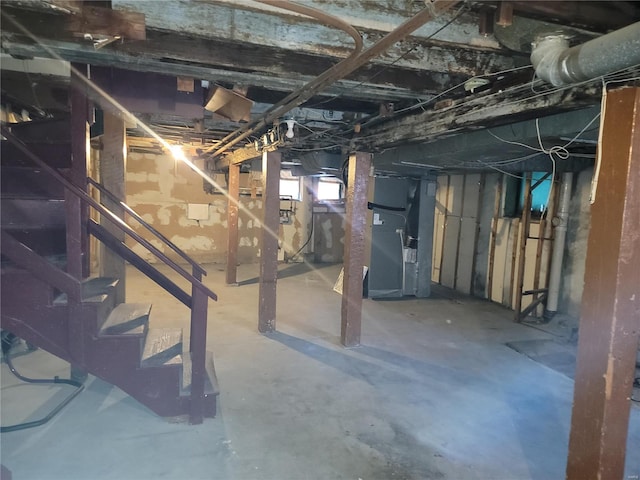 basement with stairs and heating unit