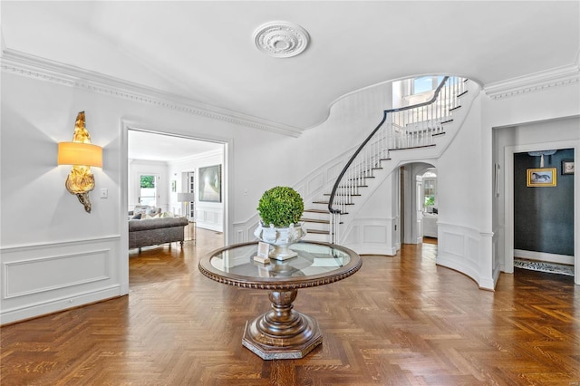 entryway featuring crown molding and parquet floors