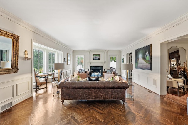 living room with parquet floors, plenty of natural light, and ornamental molding