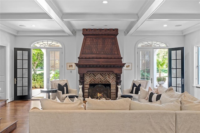 living room featuring plenty of natural light, coffered ceiling, and a brick fireplace