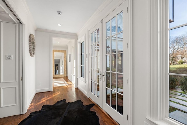 doorway featuring french doors, ornamental molding, and dark hardwood / wood-style flooring