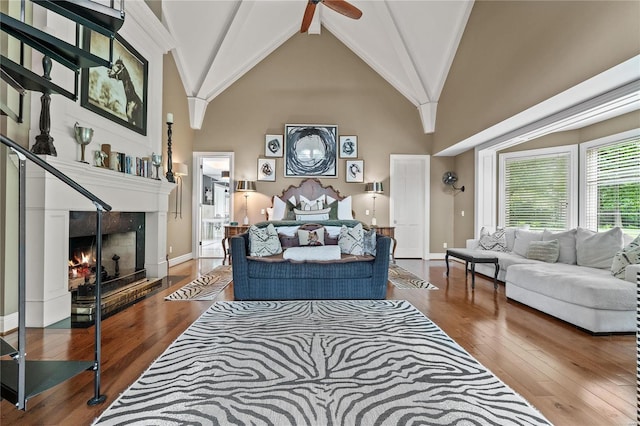 living room featuring ceiling fan, hardwood / wood-style flooring, high vaulted ceiling, and beamed ceiling