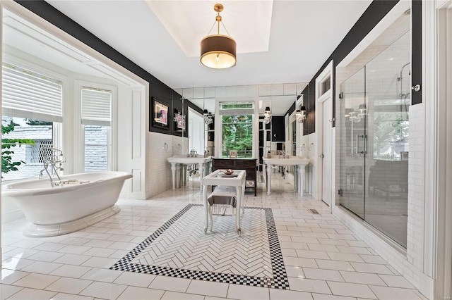 bathroom featuring separate shower and tub, tile walls, and tile patterned floors